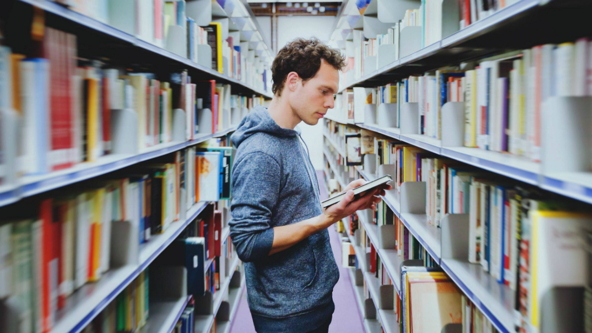 Student in the library Shutterstock
